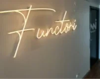Neon Functori sign on an office wall